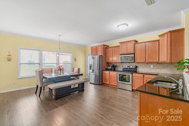 1219 Century Dr, Clover, SC 29710 - kitchen with appliances with stainless steel finishes, a sink, tasteful backsplash, dark stone countertops, and dark wood finished floors