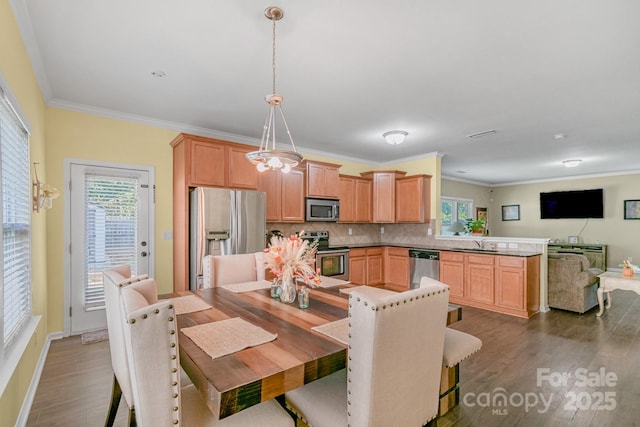 1219 Century Dr, Clover, SC 29710 - dining area with wood finished floors, crown molding, and baseboards