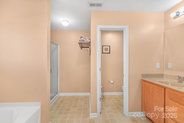 1219 Century Dr, Clover, SC 29710 - bathroom featuring toilet, a stall shower, vanity, baseboards, and a tub