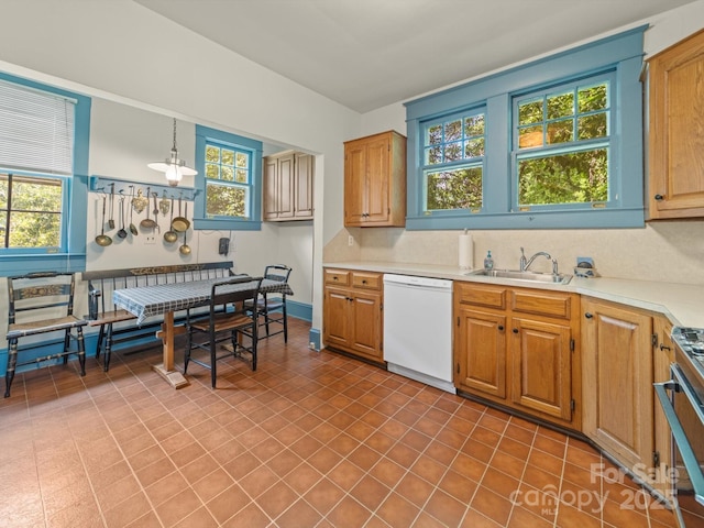 kitchen with range with gas stovetop, light countertops, dishwasher, a sink, and hanging light fixtures