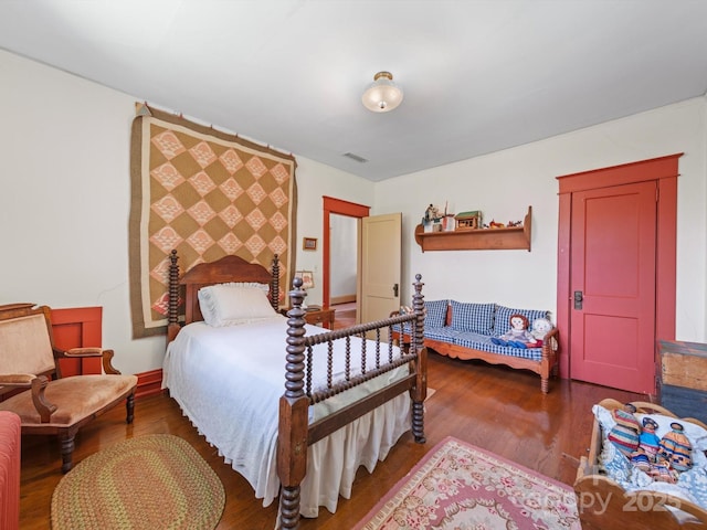 bedroom with wood finished floors and visible vents