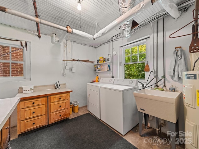 washroom with water heater, separate washer and dryer, and laundry area