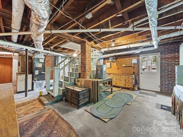 below grade area with stairway and brick wall