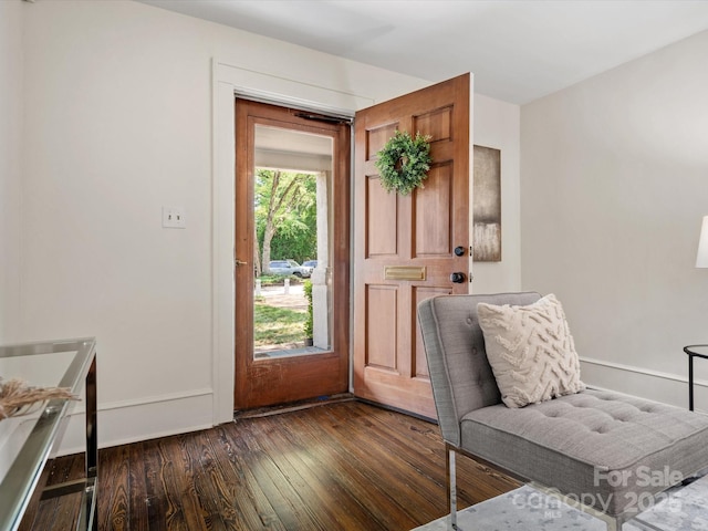 doorway to outside with dark wood-style flooring and baseboards