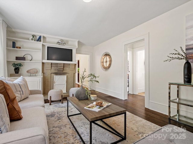 living area featuring baseboards and wood finished floors