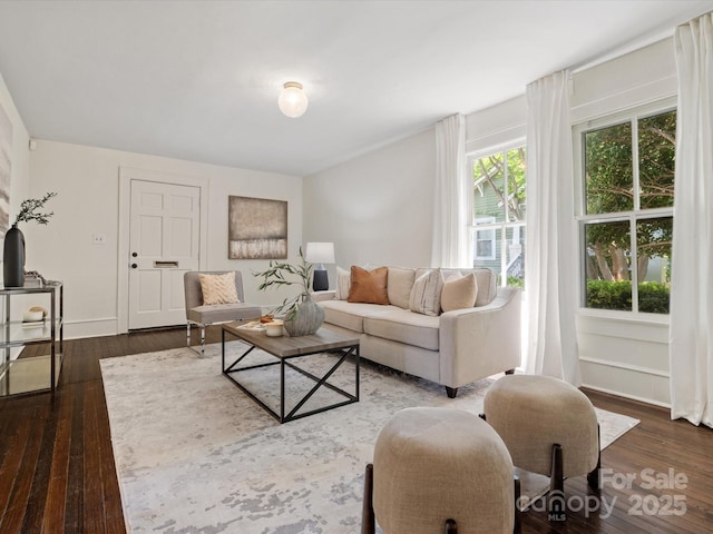 living room featuring baseboards and hardwood / wood-style floors
