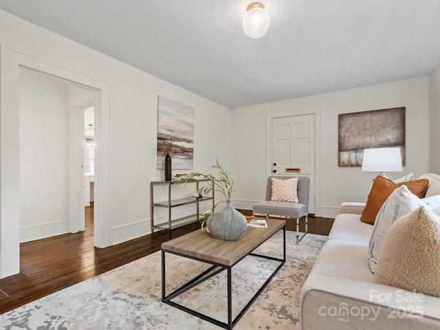 living room featuring baseboards and wood finished floors