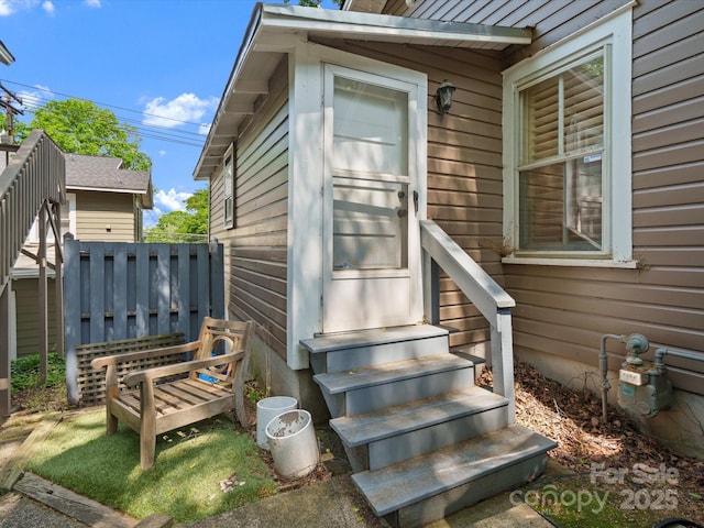 entrance to property featuring fence