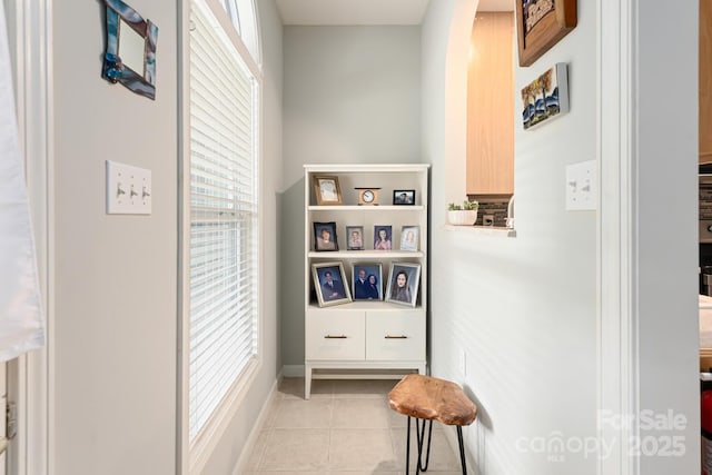 hall with light tile patterned floors and baseboards