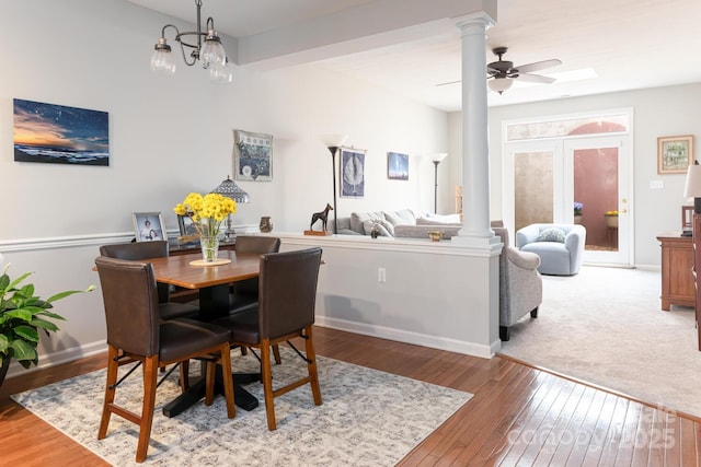 dining room featuring a ceiling fan, hardwood / wood-style floors, decorative columns, and baseboards