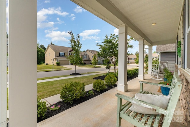 view of patio featuring covered porch and a residential view