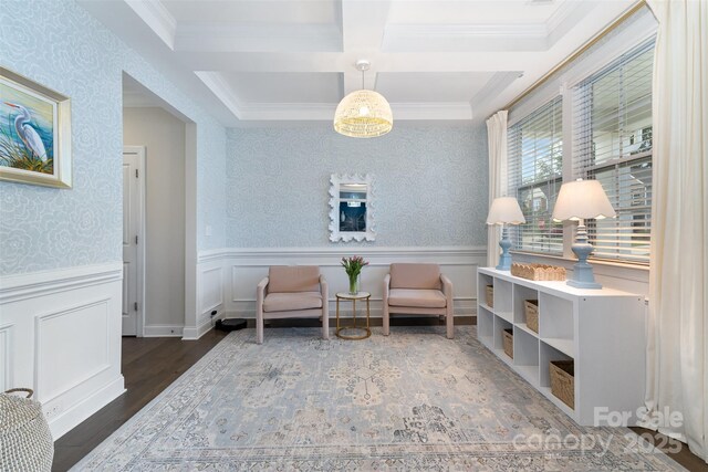 living area featuring coffered ceiling, crown molding, a wainscoted wall, beamed ceiling, and wood finished floors