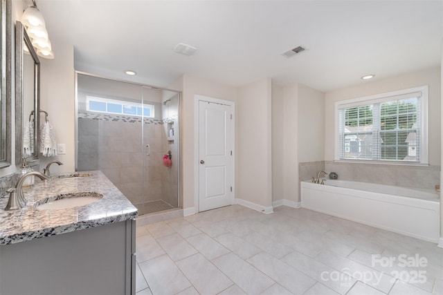 bathroom featuring tile patterned flooring, a bath, double vanity, a shower stall, and recessed lighting