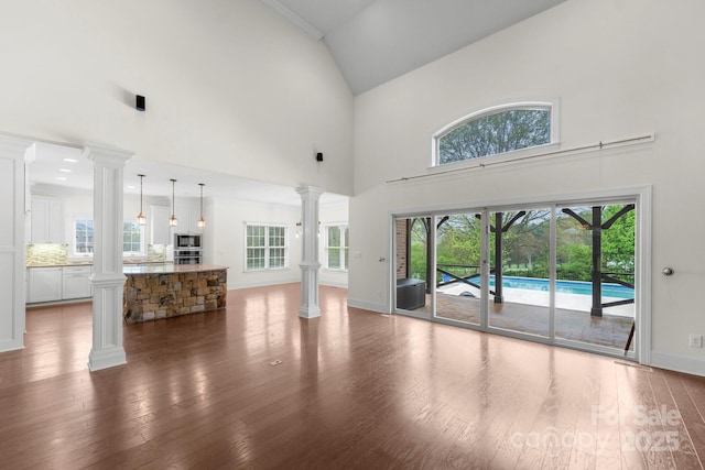 1012 Harper Lee Dr, Newton, NC 28658 - unfurnished living room with baseboards, wood finished floors, and decorative columns