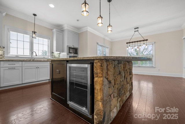 1012 Harper Lee Dr, Newton, NC 28658 - kitchen with stainless steel microwave, ornamental molding, wine cooler, a sink, and dark wood-style floors