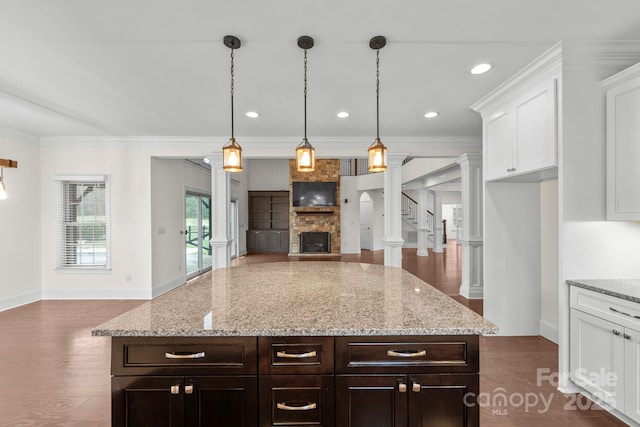 1012 Harper Lee Dr, Newton, NC 28658 - kitchen featuring ornate columns, a fireplace, white cabinets, and open floor plan