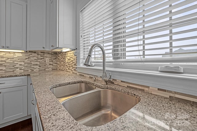 1012 Harper Lee Dr, Newton, NC 28658 - details with backsplash, light stone countertops, and a sink