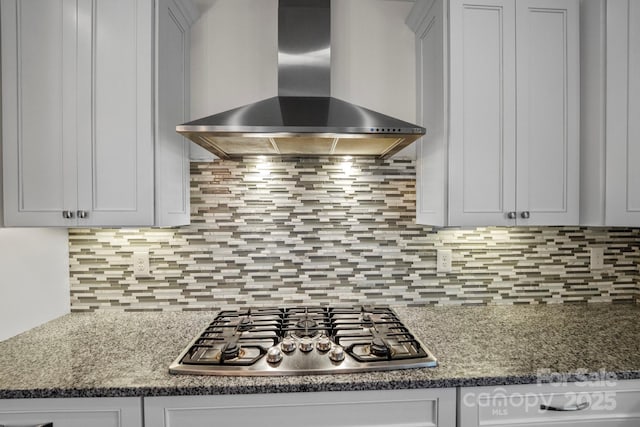 1012 Harper Lee Dr, Newton, NC 28658 - kitchen with wall chimney range hood, stainless steel gas stovetop, dark stone counters, and tasteful backsplash