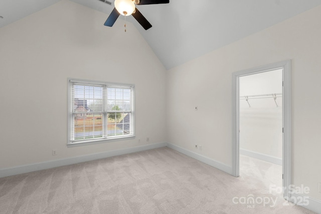 1012 Harper Lee Dr, Newton, NC 28658 - unfurnished bedroom featuring a walk in closet, light colored carpet, high vaulted ceiling, baseboards, and a ceiling fan