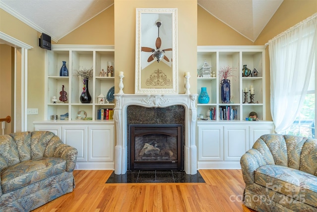 59 Carriage Highlands Ct, Hendersonville, NC 28791 - living area featuring wood finished floors, lofted ceiling, and a fireplace with flush hearth