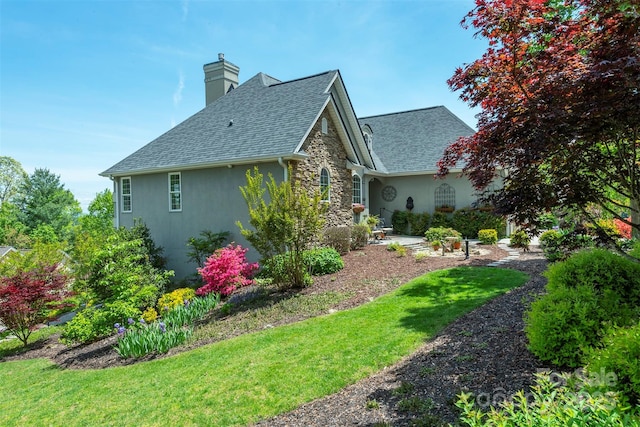 59 Carriage Highlands Ct, Hendersonville, NC 28791 - view of side of property with stone siding, stucco siding, a chimney, a shingled roof, and a yard