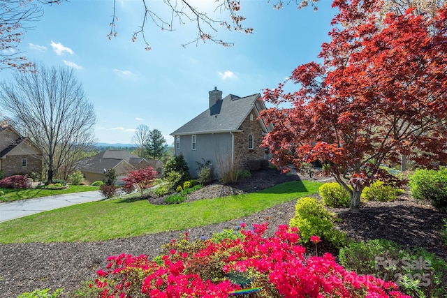 59 Carriage Highlands Ct, Hendersonville, NC 28791 - view of property exterior featuring stone siding, a yard, and a chimney