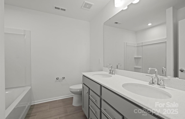 bathroom with visible vents, toilet, and a sink