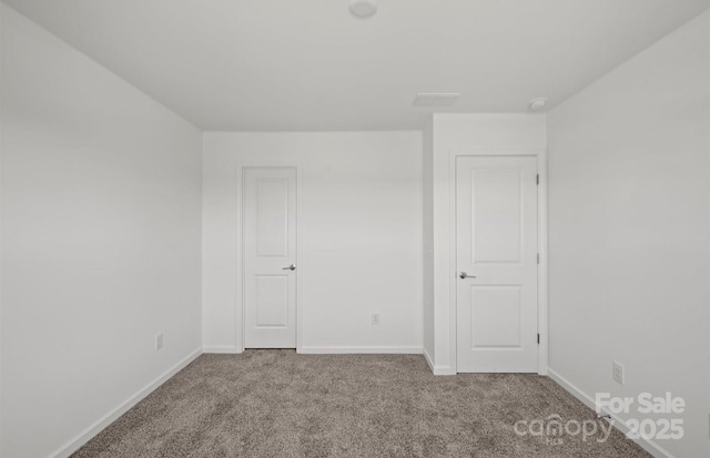 unfurnished bedroom with carpet and baseboards