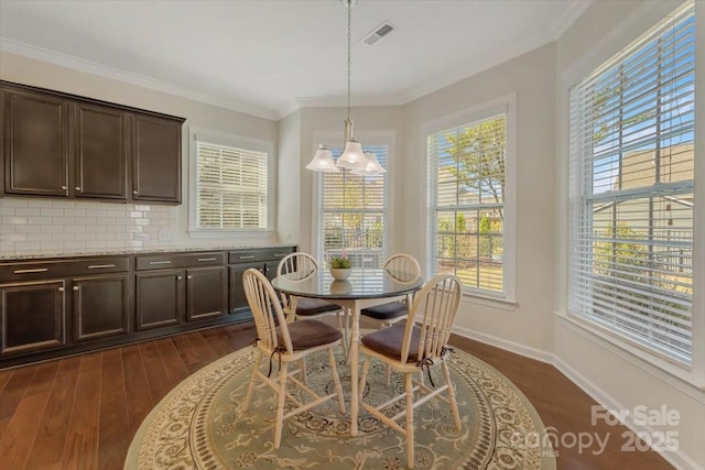 13311 Union Square Dr, Huntersville, NC 28078 - dining space featuring visible vents, baseboards, a notable chandelier, ornamental molding, and dark wood-type flooring