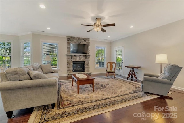 13311 Union Square Dr, Huntersville, NC 28078 - living room featuring ornamental molding, a stone fireplace, a ceiling fan, recessed lighting, and wood finished floors