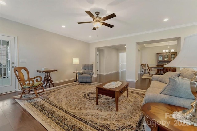 13311 Union Square Dr, Huntersville, NC 28078 - living room featuring baseboards, crown molding, recessed lighting, wood finished floors, and ceiling fan with notable chandelier