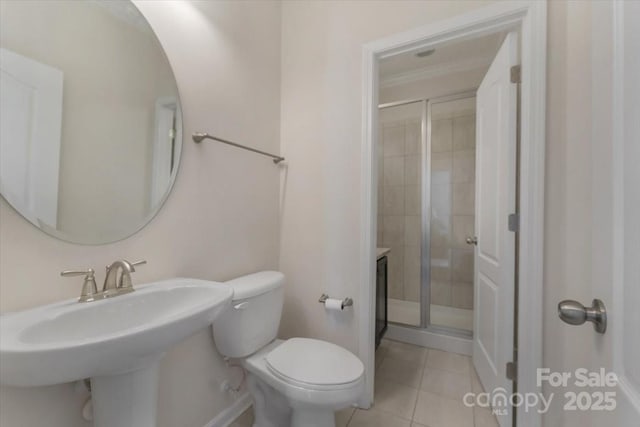 13311 Union Square Dr, Huntersville, NC 28078 - bathroom featuring toilet, a shower stall, tile patterned flooring, and baseboards