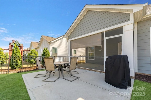 13311 Union Square Dr, Huntersville, NC 28078 - view of patio with a sunroom, area for grilling, outdoor dining space, and fence