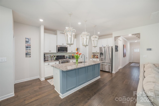 kitchen featuring a sink, white cabinets, appliances with stainless steel finishes, and dark wood-style flooring