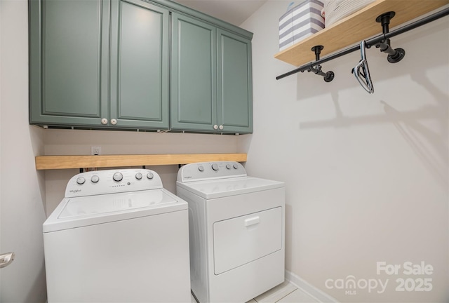 laundry room featuring cabinet space, washer and clothes dryer, and baseboards