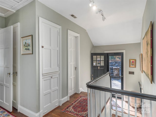 250 Kimberly Ave, Asheville, NC 28804 - hallway with an upstairs landing, lofted ceiling, baseboards, visible vents, and dark wood-style flooring