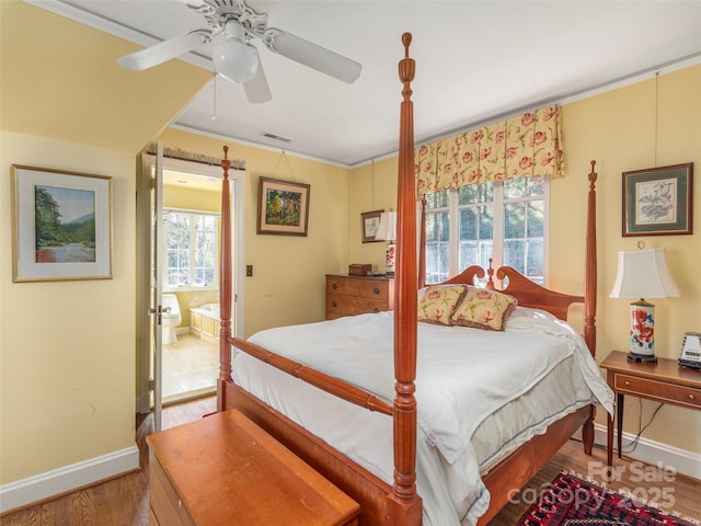 250 Kimberly Ave, Asheville, NC 28804 - bedroom featuring crown molding, wood finished floors, ensuite bathroom, baseboards, and visible vents