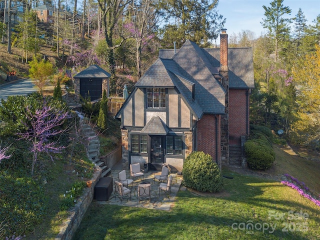 250 Kimberly Ave, Asheville, NC 28804 - exterior space featuring stairs, a patio area, a chimney, a shingled roof, and a lawn