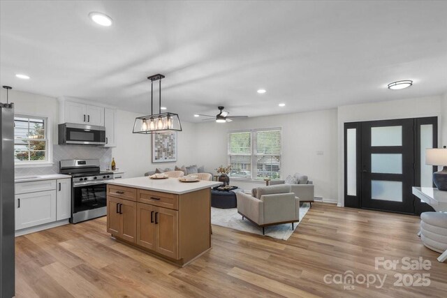 4932 Delivau Dr, Charlotte, NC 28215 - kitchen with stainless steel appliances, open floor plan, healthy amount of natural light, light countertops, and recessed lighting