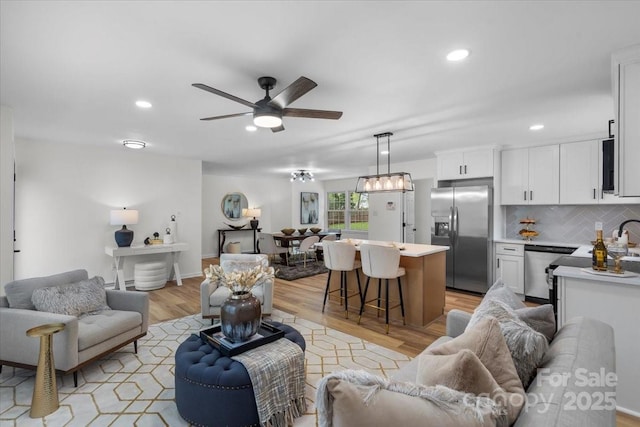 4932 Delivau Dr, Charlotte, NC 28215 - living room with ceiling fan, light wood-style floors, and recessed lighting