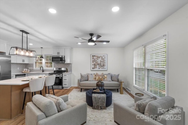 4932 Delivau Dr, Charlotte, NC 28215 - living area featuring a ceiling fan, recessed lighting, and light wood finished floors