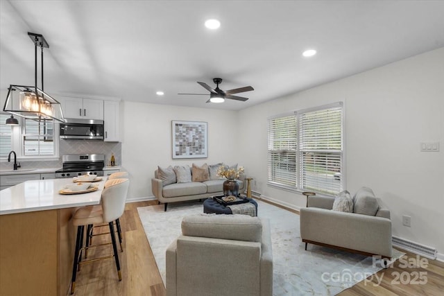 4932 Delivau Dr, Charlotte, NC 28215 - living room featuring ceiling fan, recessed lighting, and light wood-type flooring