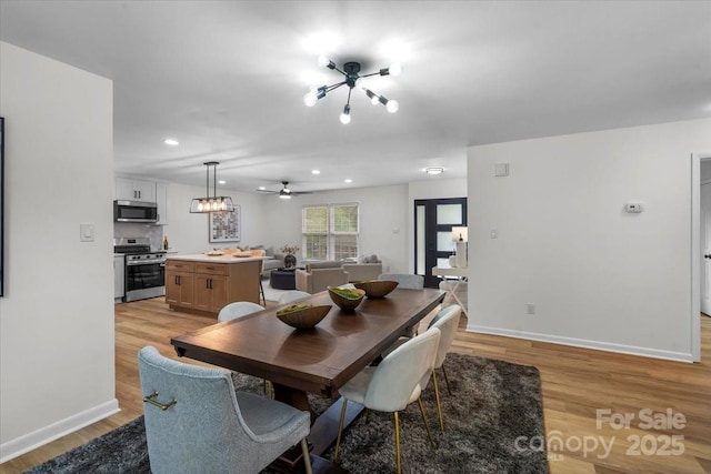 4932 Delivau Dr, Charlotte, NC 28215 - dining space featuring light wood-style floors, recessed lighting, a ceiling fan, and a chandelier