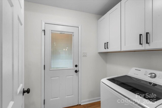 4932 Delivau Dr, Charlotte, NC 28215 - laundry room with washer / dryer, cabinet space, and wood finished floors