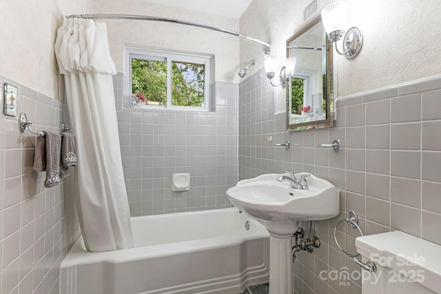 4 Dogwood Rd, Asheville, NC 28804 - bathroom featuring tile walls, shower / bath combo with shower curtain, and a wainscoted wall