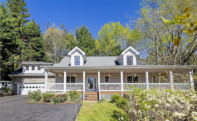101 Skyview Dr, Asheville, NC 28804 - view of front of home with covered porch, asphalt driveway, a garage, and stone siding