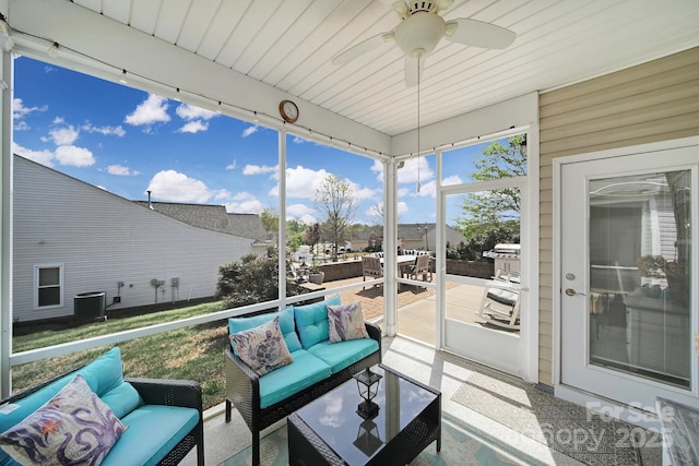 sunroom / solarium featuring outdoor lounge area, ceiling fan, and outdoor dining space