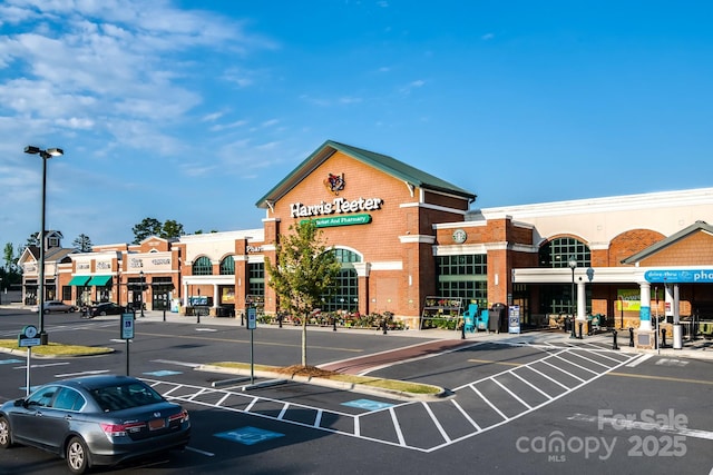 view of building exterior with uncovered parking
