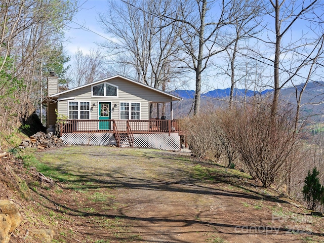 364 Blevins Knob Dr, Burnsville, NC 28714 - view of front of home with a deck with mountain view, a chimney, and a front yard