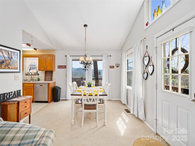 364 Blevins Knob Dr, Burnsville, NC 28714 - dining space with light carpet, baseboards, vaulted ceiling, and an inviting chandelier